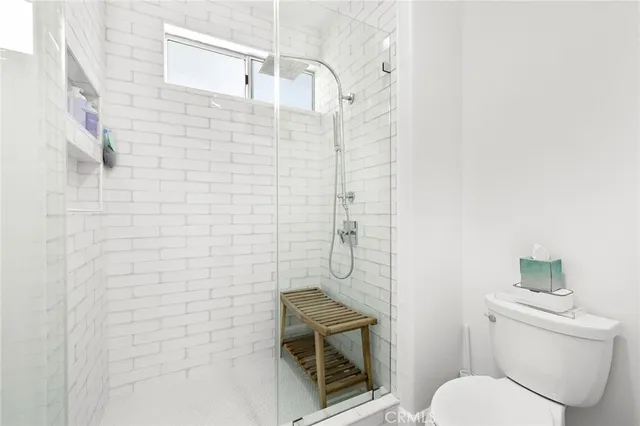 a bathroom with a toilet and a shower