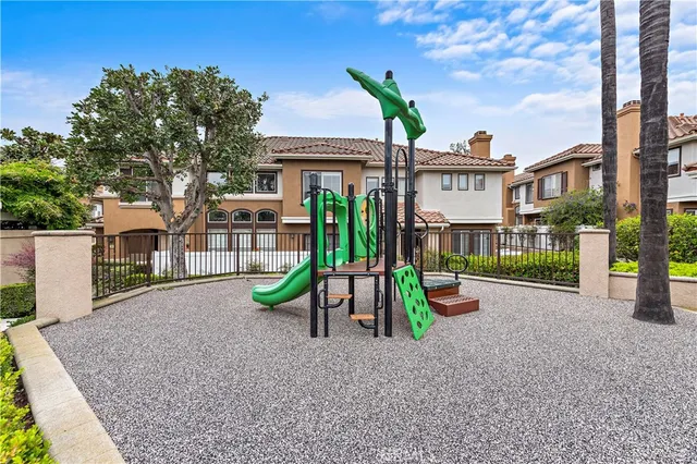 a view of a park with iron fence