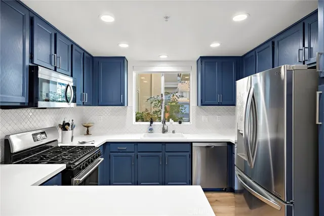 a kitchen with a refrigerator and a sink