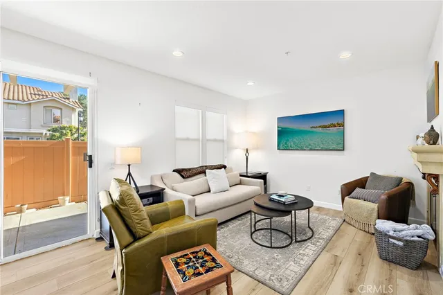 a living room with furniture a rug and a window