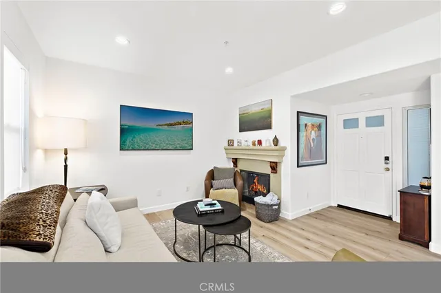 a living room with furniture a flat screen tv and a lamp