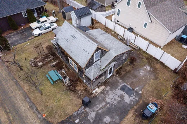 an aerial view of a house with a yard