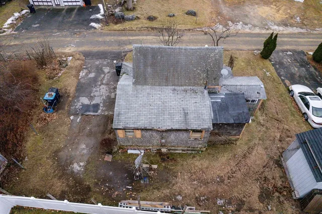 an aerial view of a house with a yard