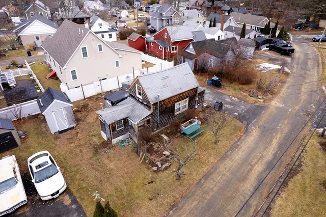an aerial view of a house with swimming pool and sitting area