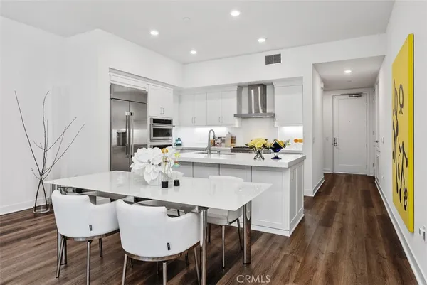 a stove top oven sitting inside of a kitchen
