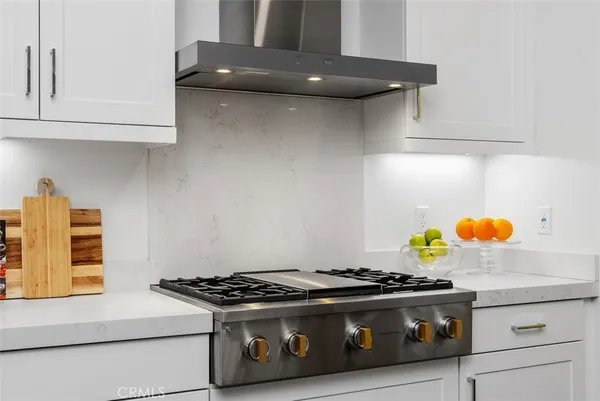 a stove top oven sitting inside of a kitchen