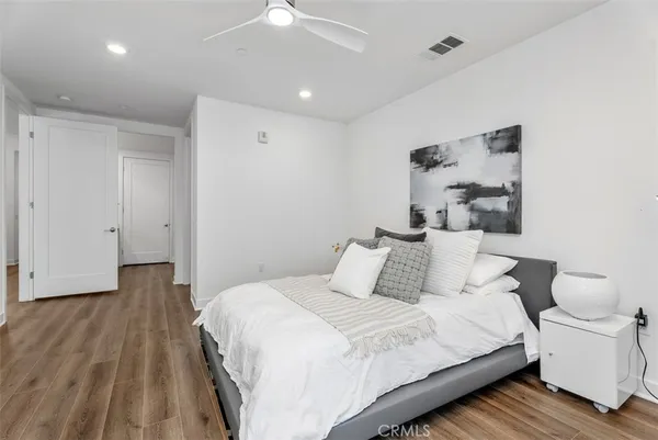 a spacious bedroom with a bed and a window