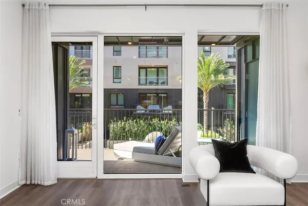 a view of a balcony with two chairs and a potted plant