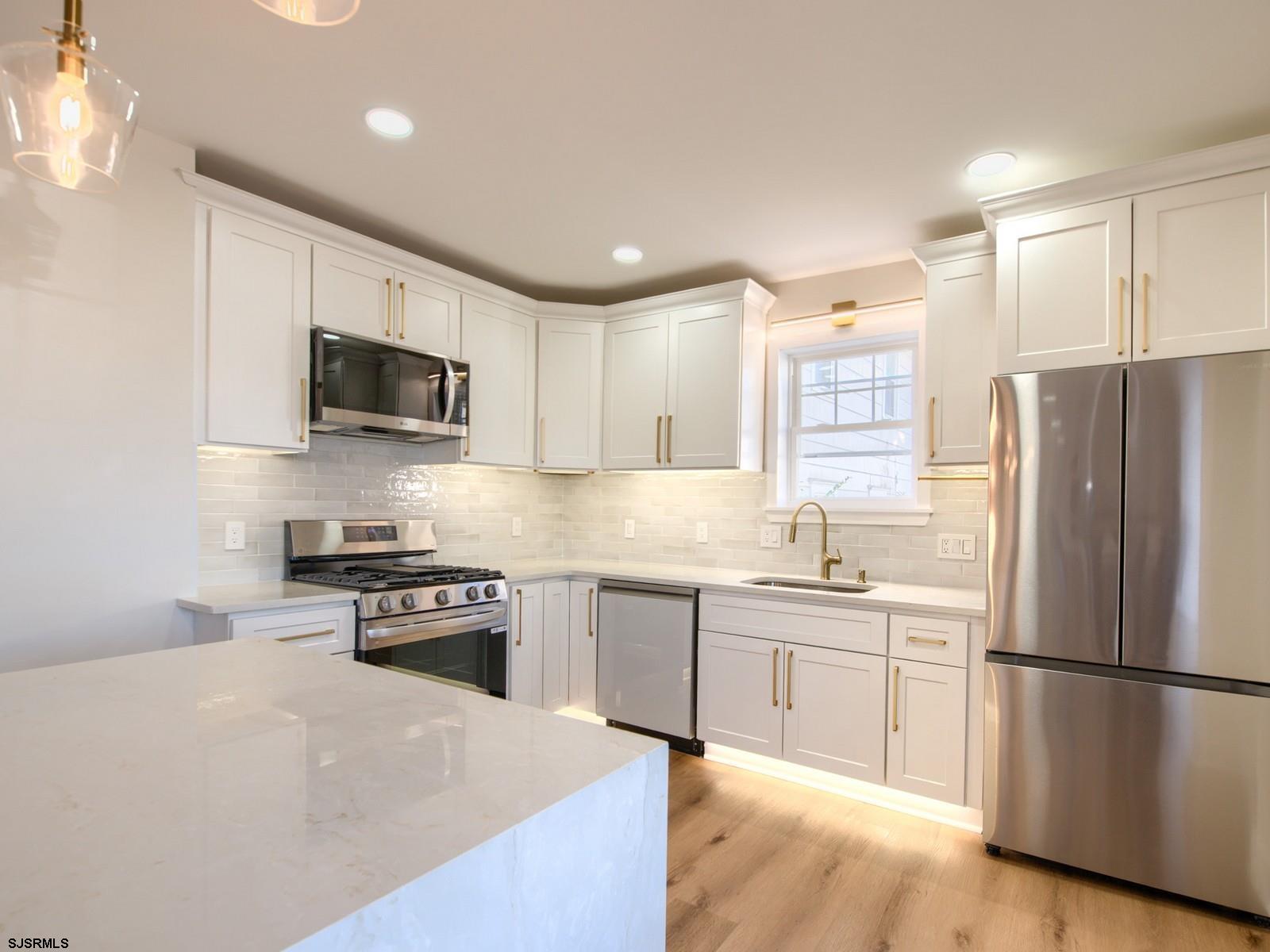 706 Augustine Road Atlantic City, NJ 08401 - Photo 14 of 56 a kitchen with stainless steel appliances granite countertop a refrigerator a stove top oven a sink and dishwasher