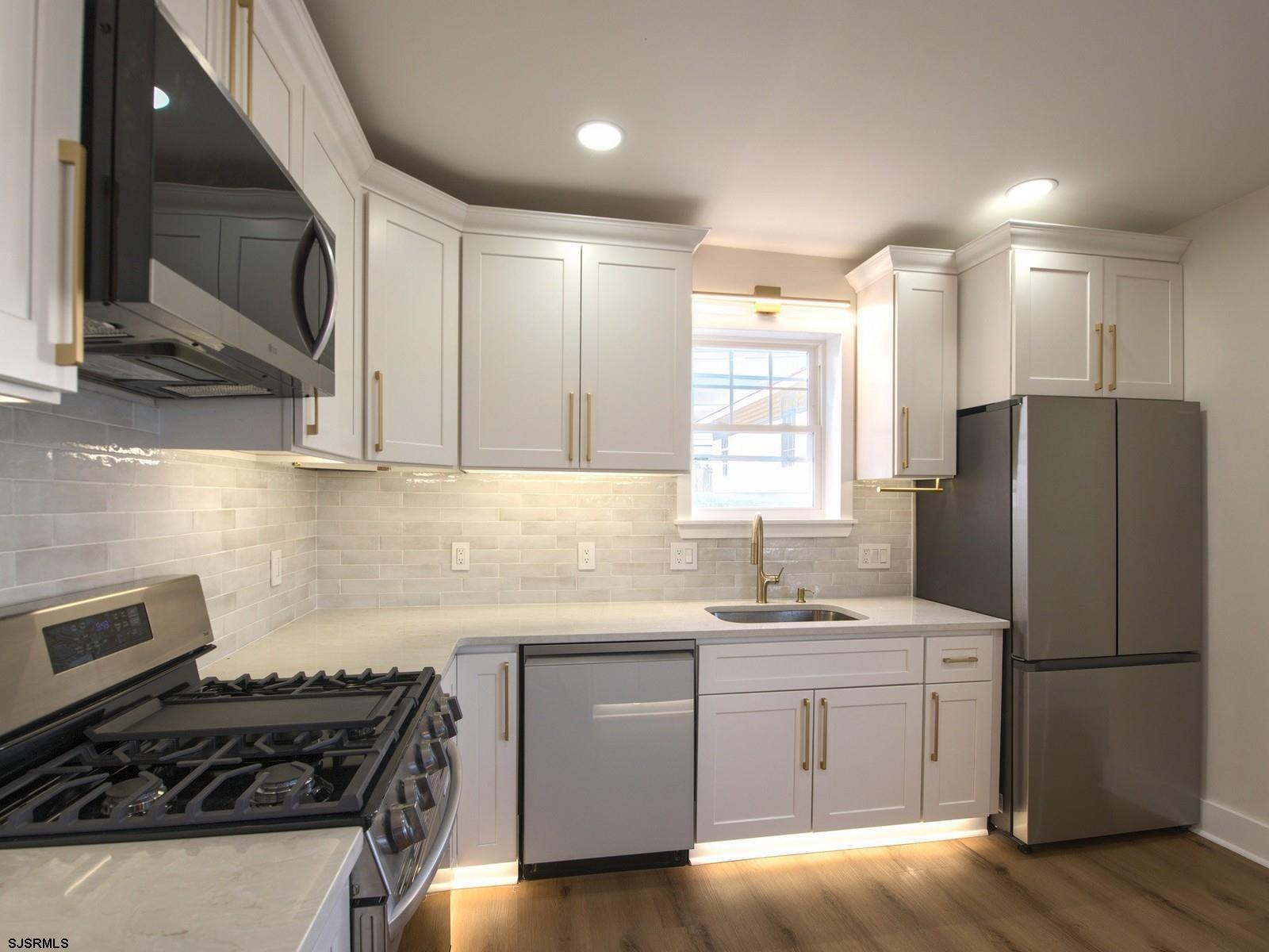 706 Augustine Road Atlantic City, NJ 08401 - Photo 15 of 56 a kitchen with a sink stove and refrigerator