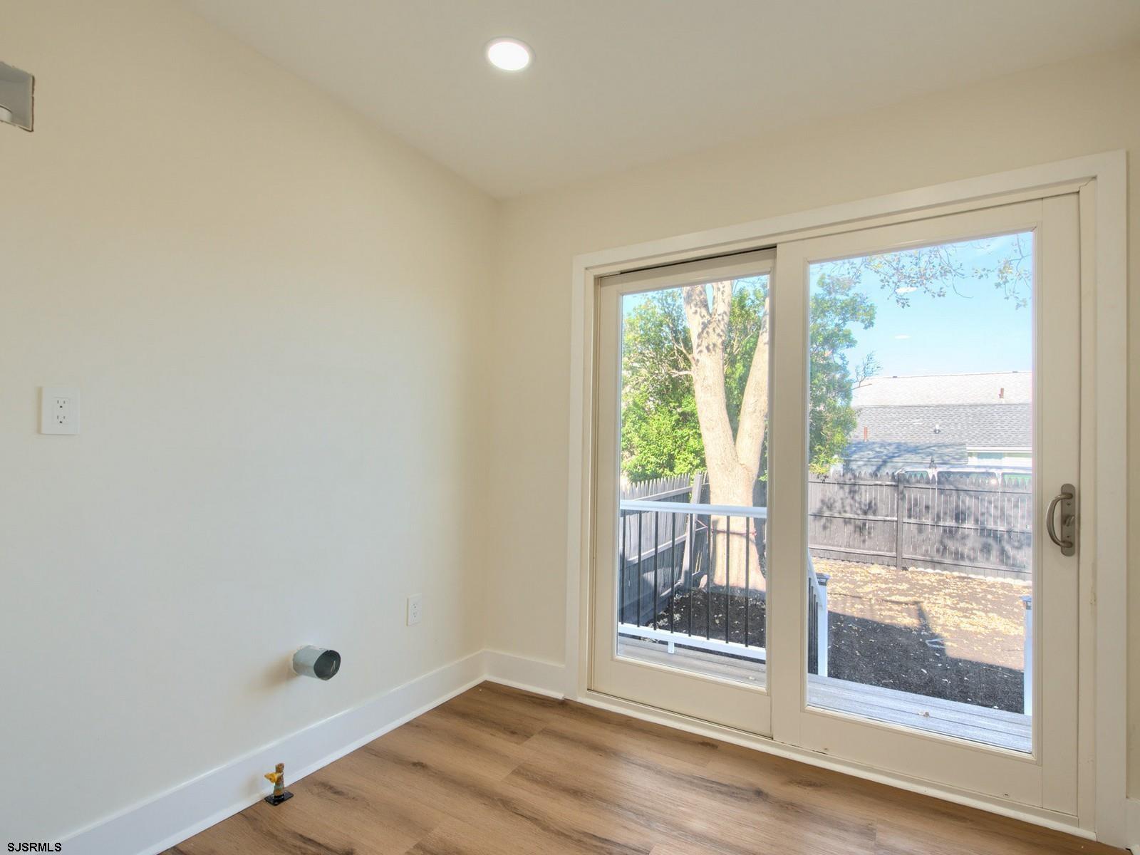 706 Augustine Road Atlantic City, NJ 08401 - Photo 16 of 56 a view of a big room with wooden floor and windows