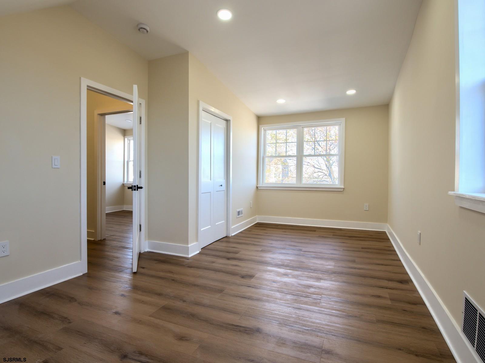 706 Augustine Road Atlantic City, NJ 08401 - Photo 26 of 56 an empty room with wooden floor and windows