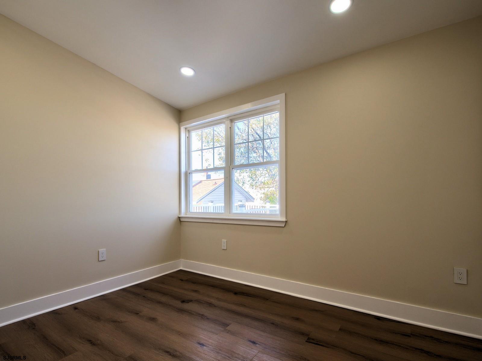 706 Augustine Road Atlantic City, NJ 08401 - Photo 30 of 56 an empty room with wooden floor and windows