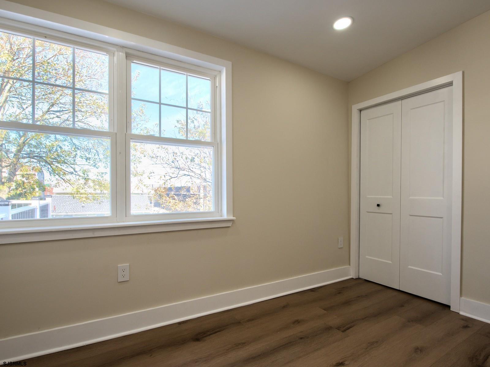 706 Augustine Road Atlantic City, NJ 08401 - Photo 31 of 56 an empty room with wooden floor and windows