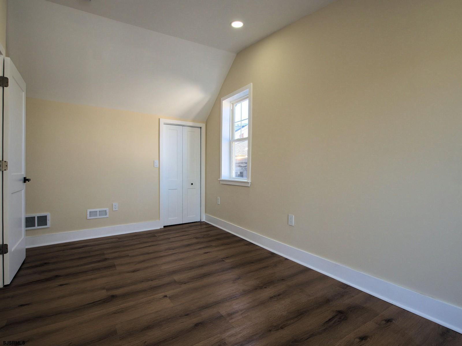 706 Augustine Road Atlantic City, NJ 08401 - Photo 32 of 56 a view of an empty room with wooden floor and a window
