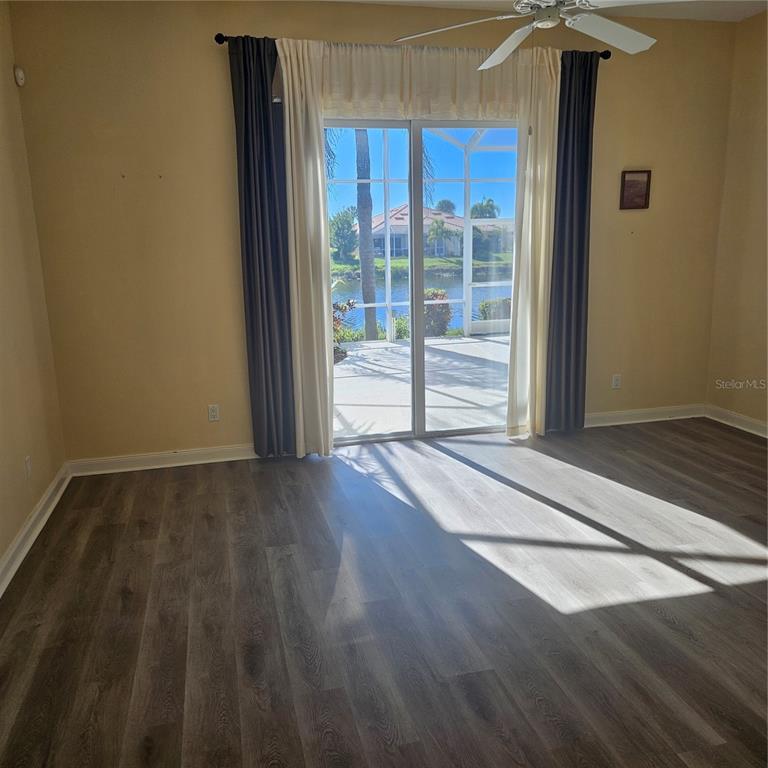 13415 Coluccio Street Venice, FL 34293 - Photo 12 of 39 a view of an empty room with wooden floor and a window