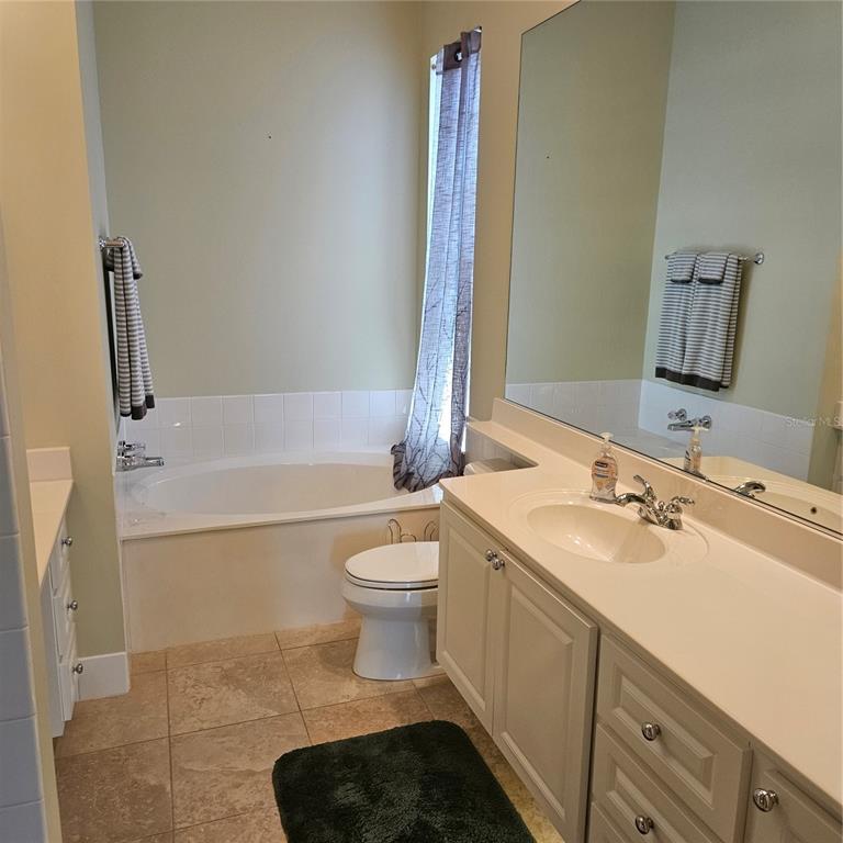 13415 Coluccio Street Venice, FL 34293 - Photo 15 of 39 a bathroom with a sink a toilet and shower