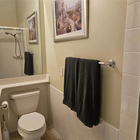 a bathroom with a toilet and a shower
