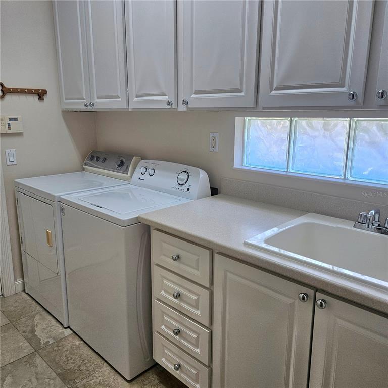 13415 Coluccio Street Venice, FL 34293 - Photo 22 of 39 a utility room with cabinets