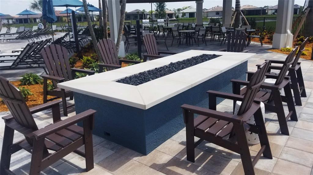 13415 Coluccio Street Venice, FL 34293 - Photo 30 of 39 a view of a patio with table and chairs and potted plants