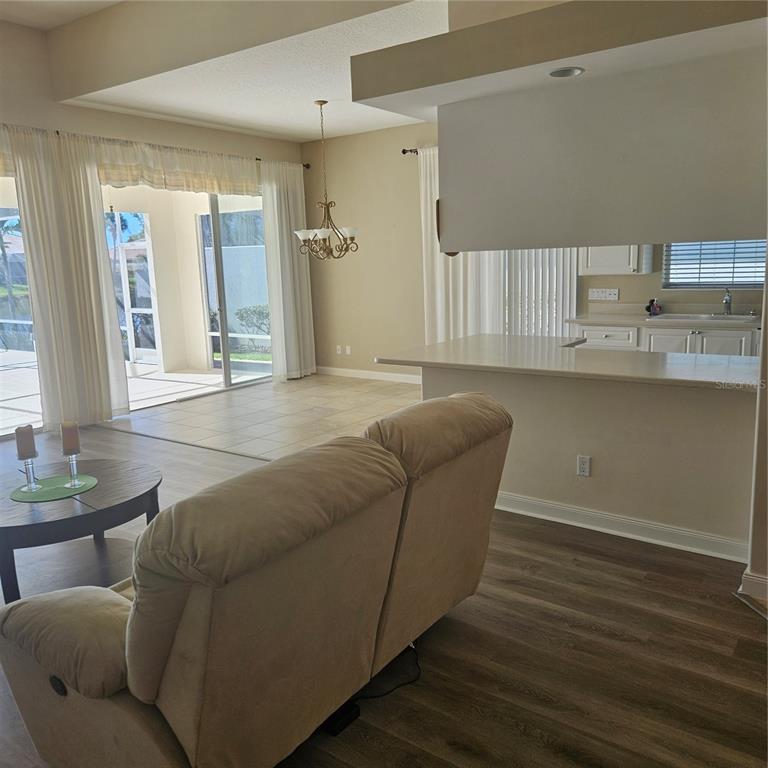 13415 Coluccio Street Venice, FL 34293 - Photo 6 of 39 a living room with furniture and wooden floor