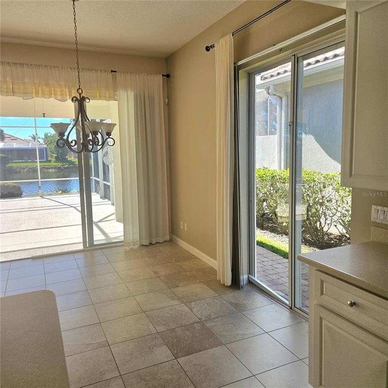 13415 Coluccio Street Venice, FL 34293 - Photo 8 of 39 a view of a glass door with a glass door and a room next to a window