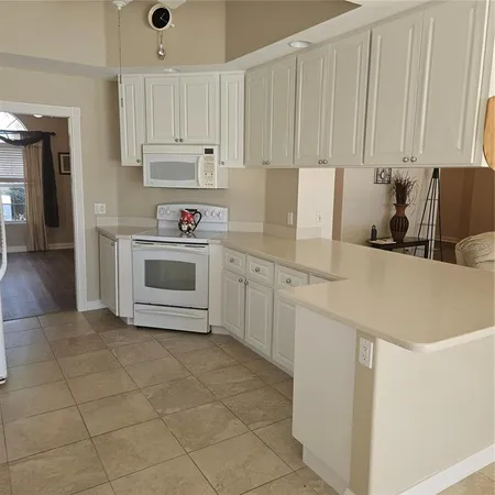 a kitchen with cabinets and white appliances