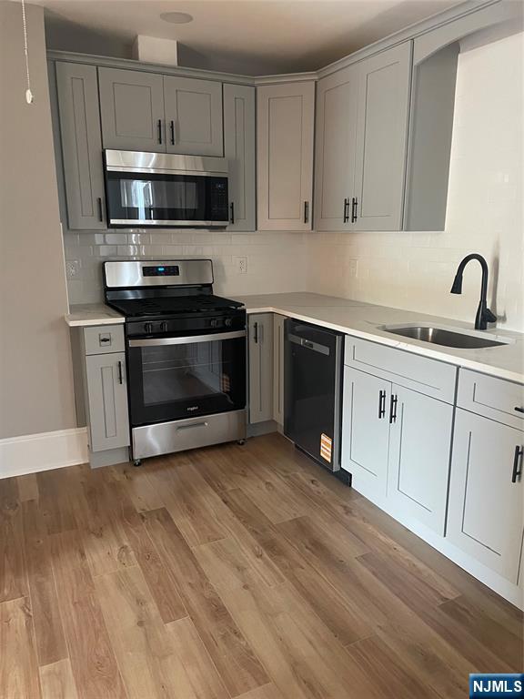 508 2nd Street, Unit 1 Carlstadt, NJ 07072 - Photo 13 of 41 a kitchen with stainless steel appliances granite countertop a stove a sink and a microwave