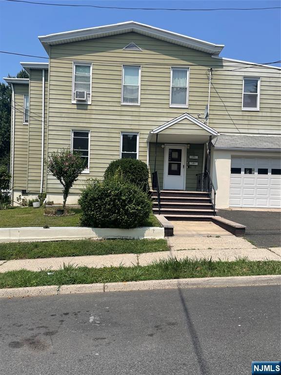 508 2nd Street, Unit 1 Carlstadt, NJ 07072 - Photo 17 of 41 a front view of a house with a yard and garage