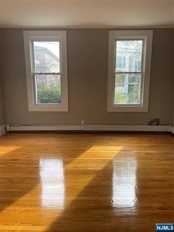 wooden floor in an empty room with a mirror