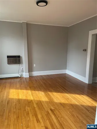 wooden floor in an empty room with a mirror
