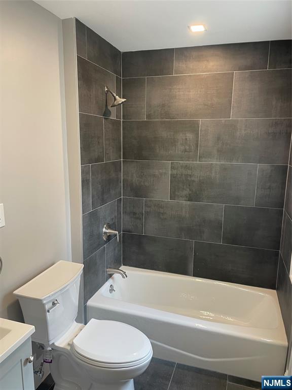 508 2nd Street, Unit 1 Carlstadt, NJ 07072 - Photo 36 of 41 a white toilet and tub sitting next to a bathroom sink