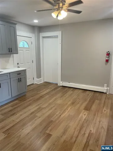 a view of a kitchen with microwave and cabinets