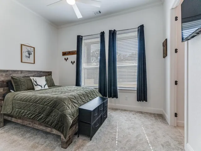 a spacious bedroom with a bed and a refrigerator