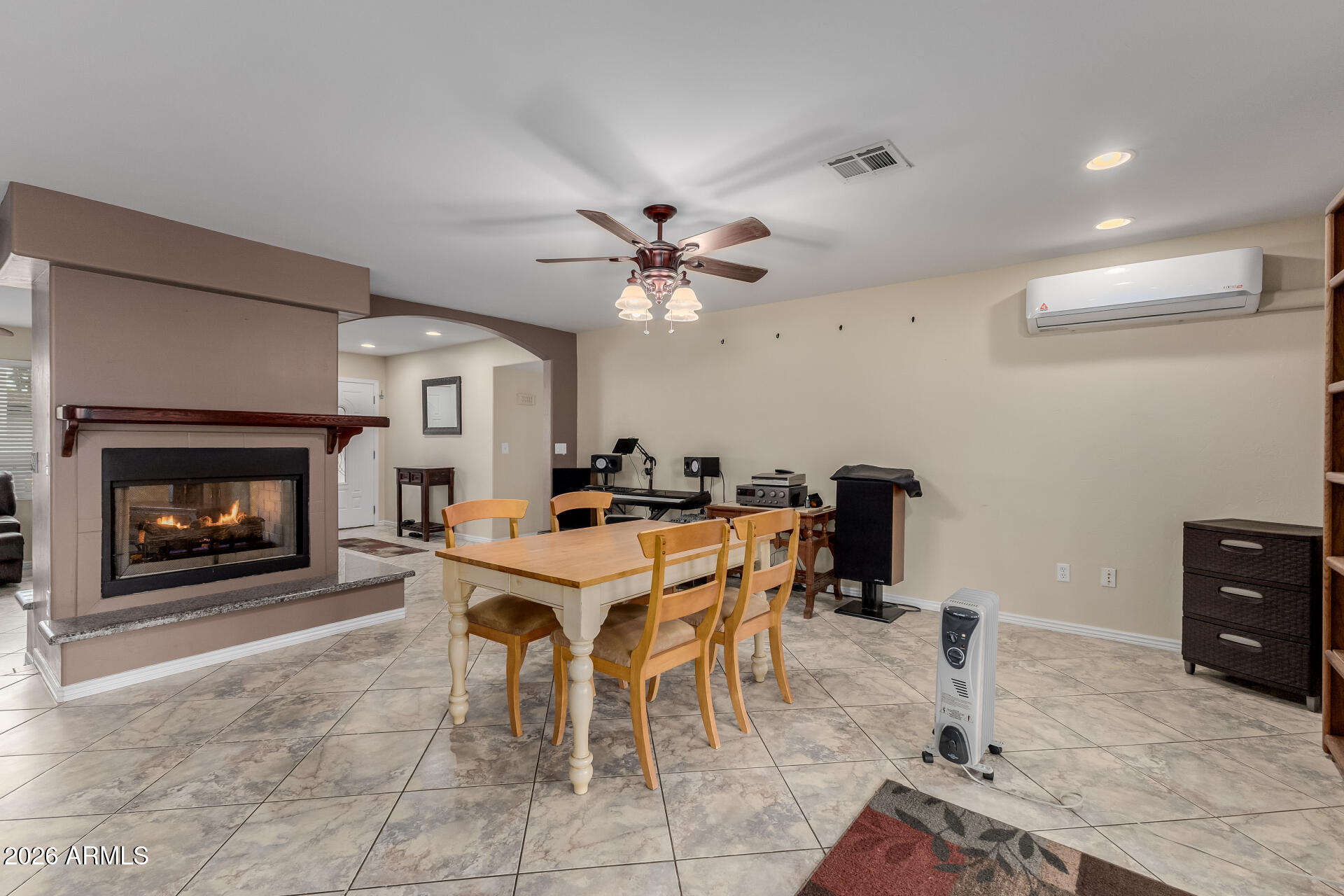 802 West Caribbean Lane Phoenix, AZ 85023 - Photo 19 of 47 a dining room with furniture and a fireplace