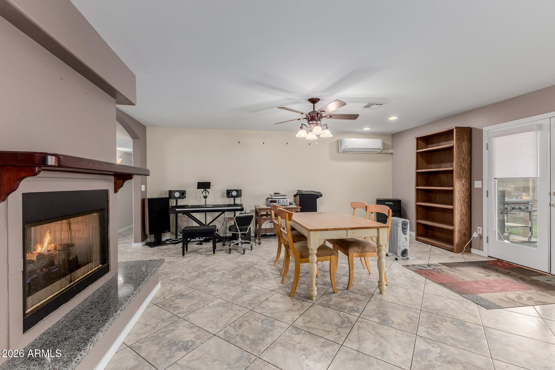802 West Caribbean Lane Phoenix, AZ 85023 - Photo 20 of 47 a living room with furniture a dining table and a fireplace