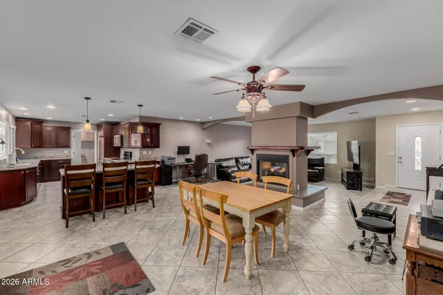 a kitchen with stainless steel appliances granite countertop a kitchen island a stove a table and chairs