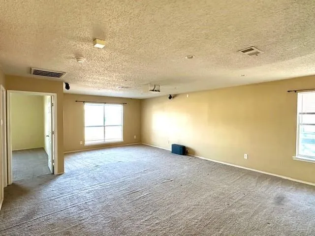 an empty room with windows and closet