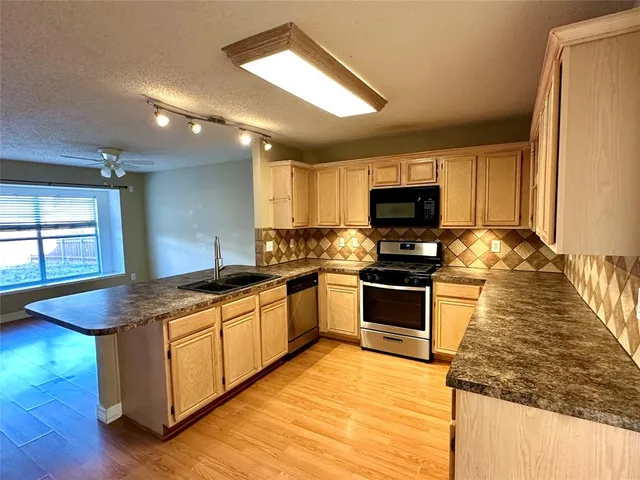 a kitchen with granite countertop a stove and a sink