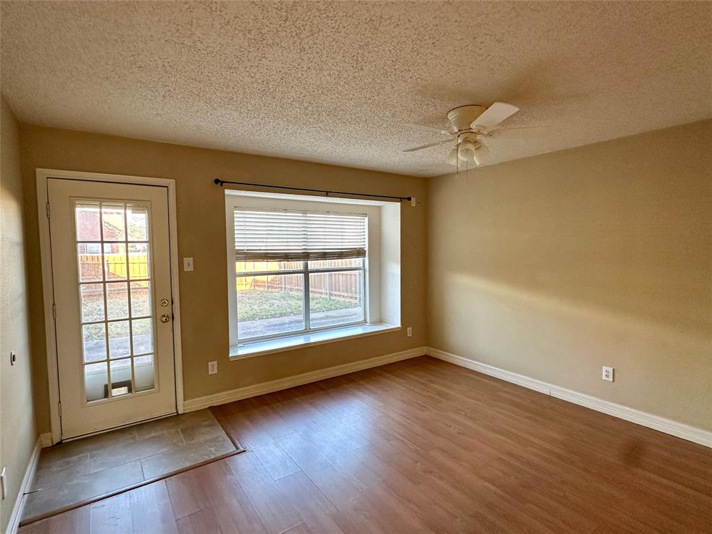 803 Squire Court Allen, TX 75002 - Photo 7 of 16 an empty room with wooden floor fan and windows