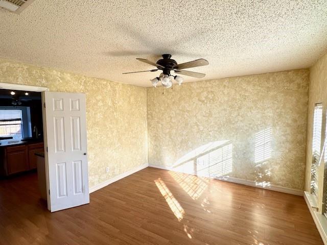 803 Squire Court Allen, TX 75002 - Photo 9 of 16 a view of a livingroom with wooden floor and a ceiling fan