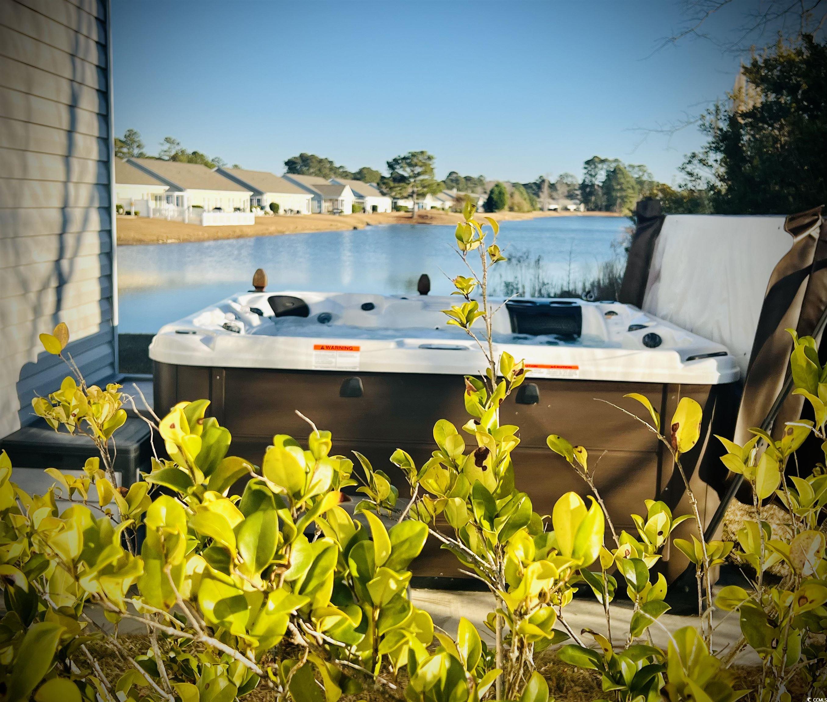 340 North Reindeer Road Surfside Beach, SC 29575 - Photo 8 of 40 Exterior space with a water view and a hot tub
