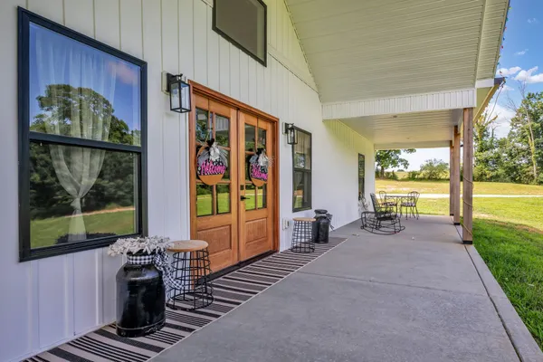 a large kitchen with stainless steel appliances kitchen island granite countertop a large kitchen island a stove a refrigerator a sink and a dining table with wooden floor