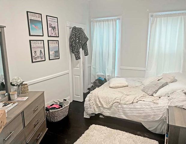 a white toilet sitting next to a shower