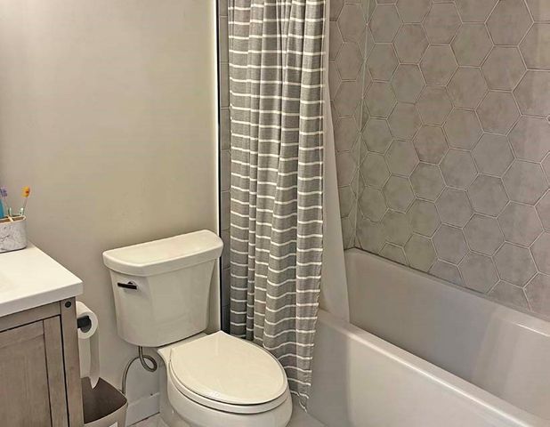 a picture of a bathroom with a shower