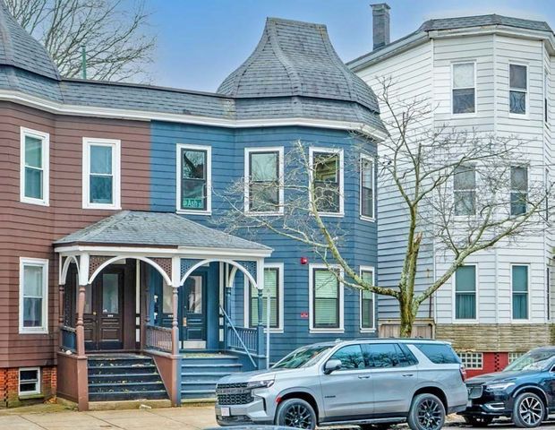 a front view of a house with parking space