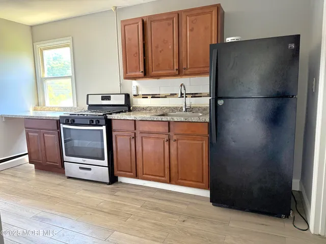a kitchen with a sink and a refrigerator