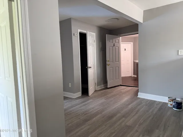 a view of a hallway with wooden floor