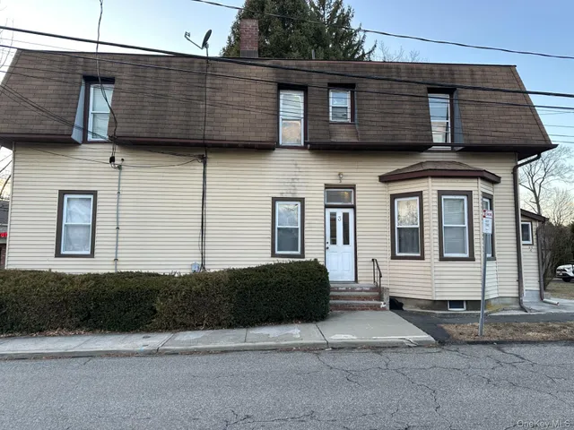 a view of a car parked front of a house