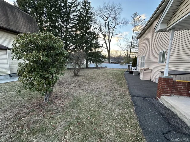 a view of a backyard with large trees